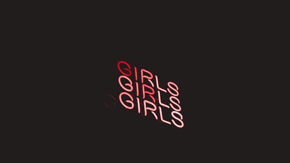Colorful neon typography and lettering on a dark wall