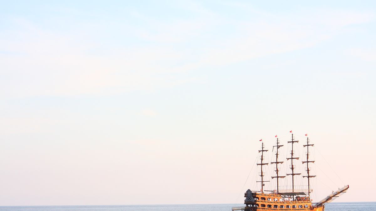 Pirate ship sailing under a skull-and-crossbones flag