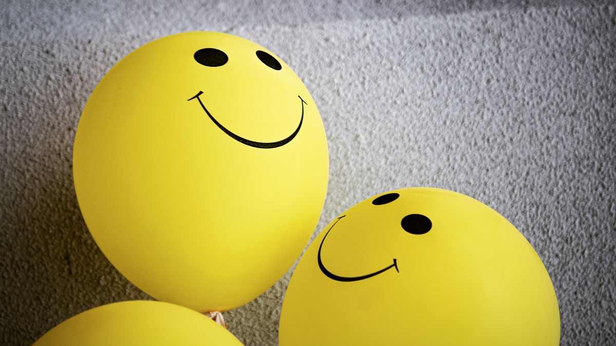 Colorful emoji icons scattered on a bright background